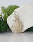 Back view of raw opal wire wrapped pendant — 925 sterling silver hand-wrapped setting, shows craftsmanship and secure stone hold, handmade in Toronto Canada