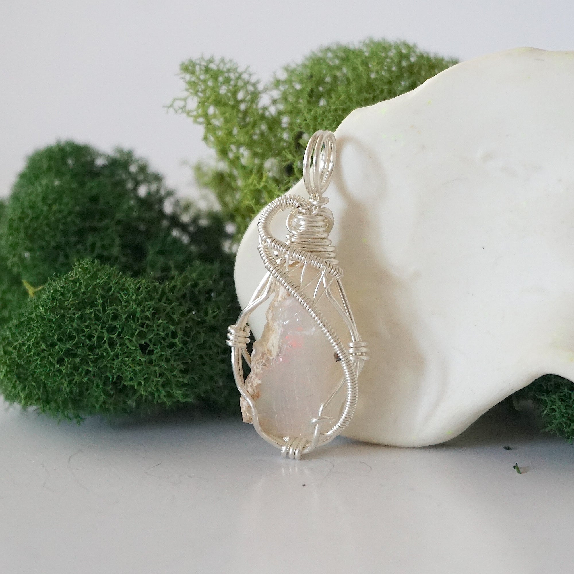 Left side detail of handmade raw opal necklace — artisan wire wrapped 925 sterling silver pendant, natural Ethiopian opal stone, ethically sourced crystal jewelry