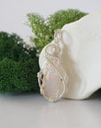 Left side detail of handmade raw opal necklace — artisan wire wrapped 925 sterling silver pendant, natural Ethiopian opal stone, ethically sourced crystal jewelry