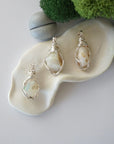 Three different raw opal pendants displayed for variation reference