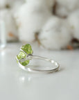 Back view of raw peridot adjustable ring showing open-back 925 sterling silver band — fits US sizes 4–10, handmade artisan August birthstone crystal ring for women