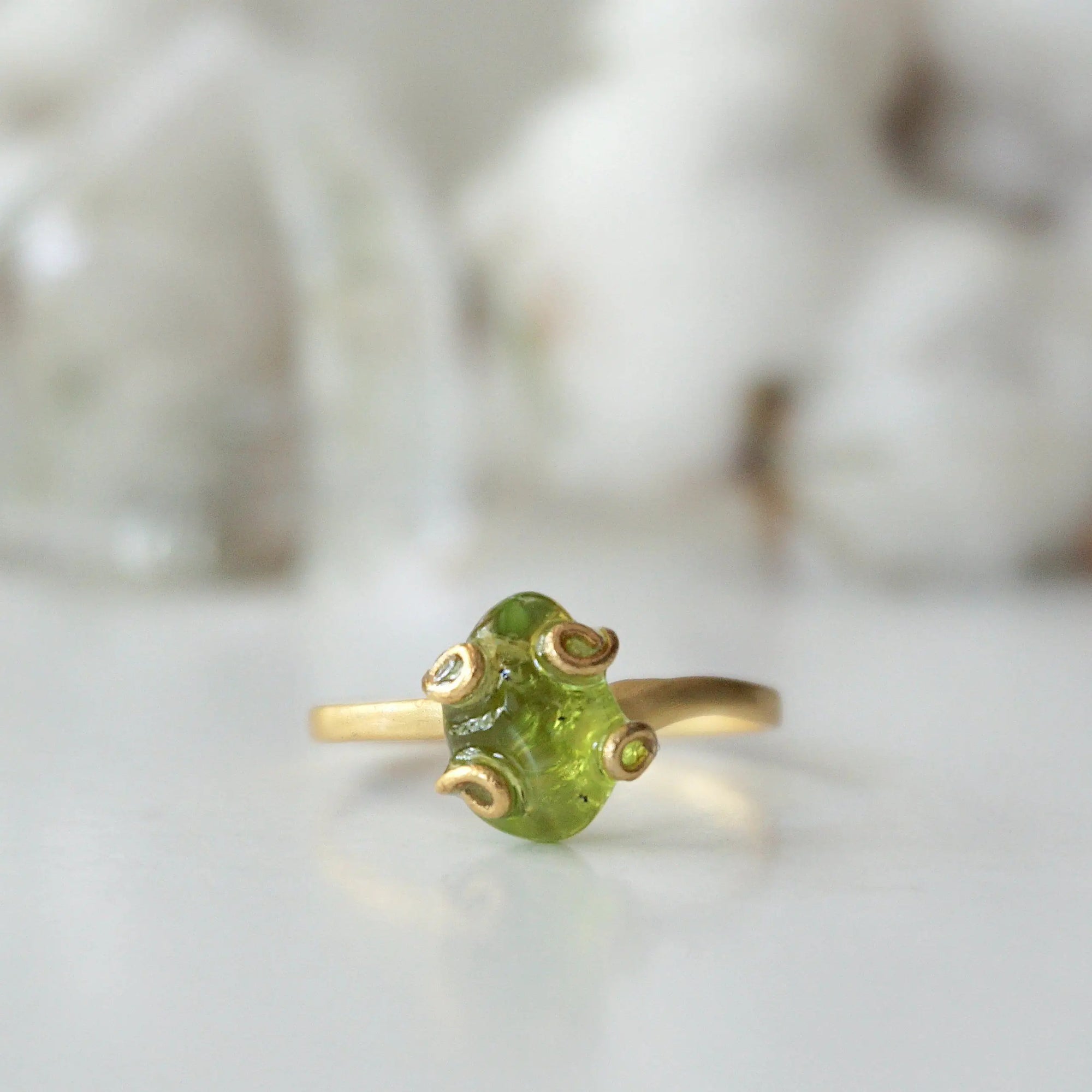 Front detail of raw peridot adjustable ring — vivid olive green natural crystal in 14k gold vermeil artisan setting, handcrafted August birthstone ring for women