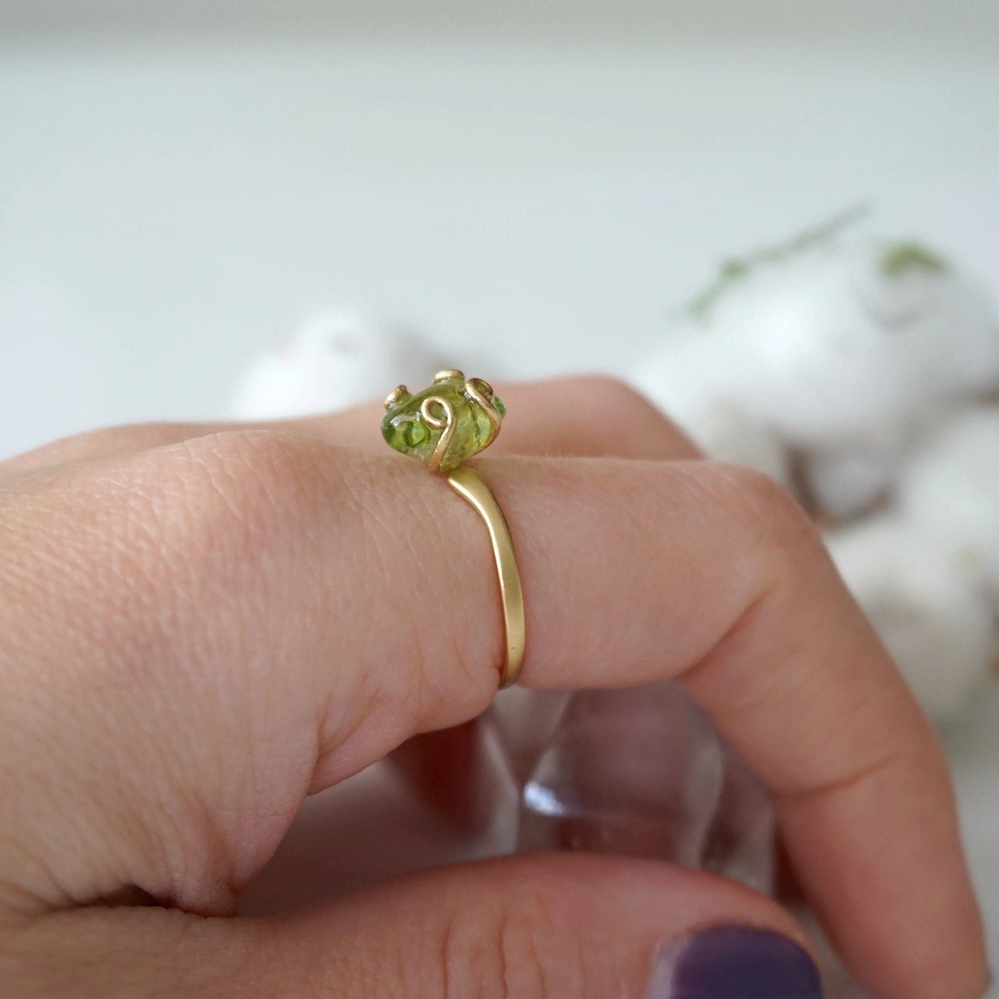 Raw peridot adjustable gold vermeil ring worn on model's hand — natural olive green crystal, adjustable August birthstone crystal ring for women by Designs by Nature Gems