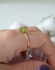 Raw peridot adjustable gold vermeil ring worn on model's hand — natural olive green crystal, adjustable August birthstone crystal ring for women by Designs by Nature Gems