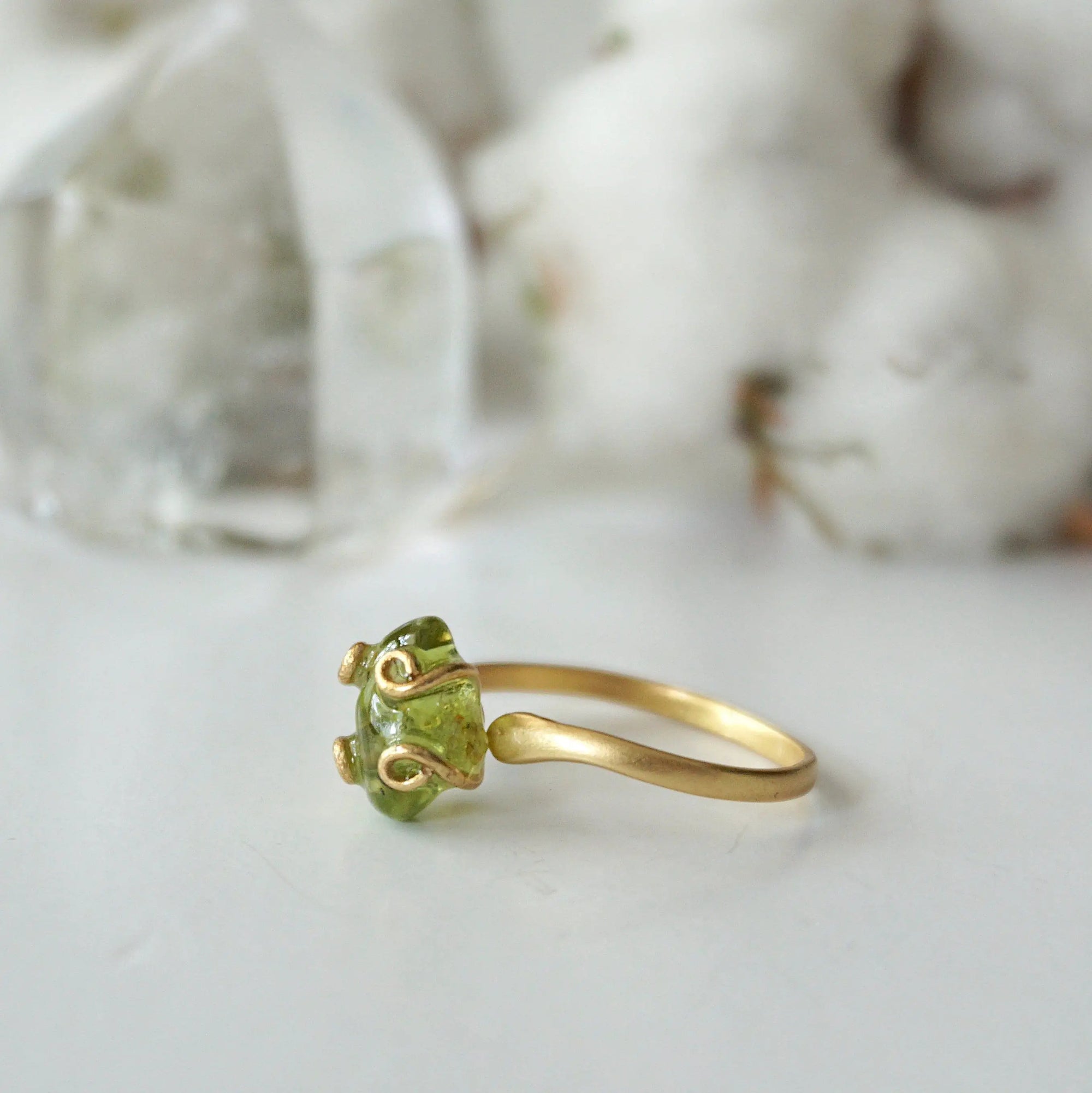 Right side angle of raw peridot adjustable ring — gold vermeil wire spiral setting and smooth band profile, dainty handcrafted August birthstone crystal ring for women