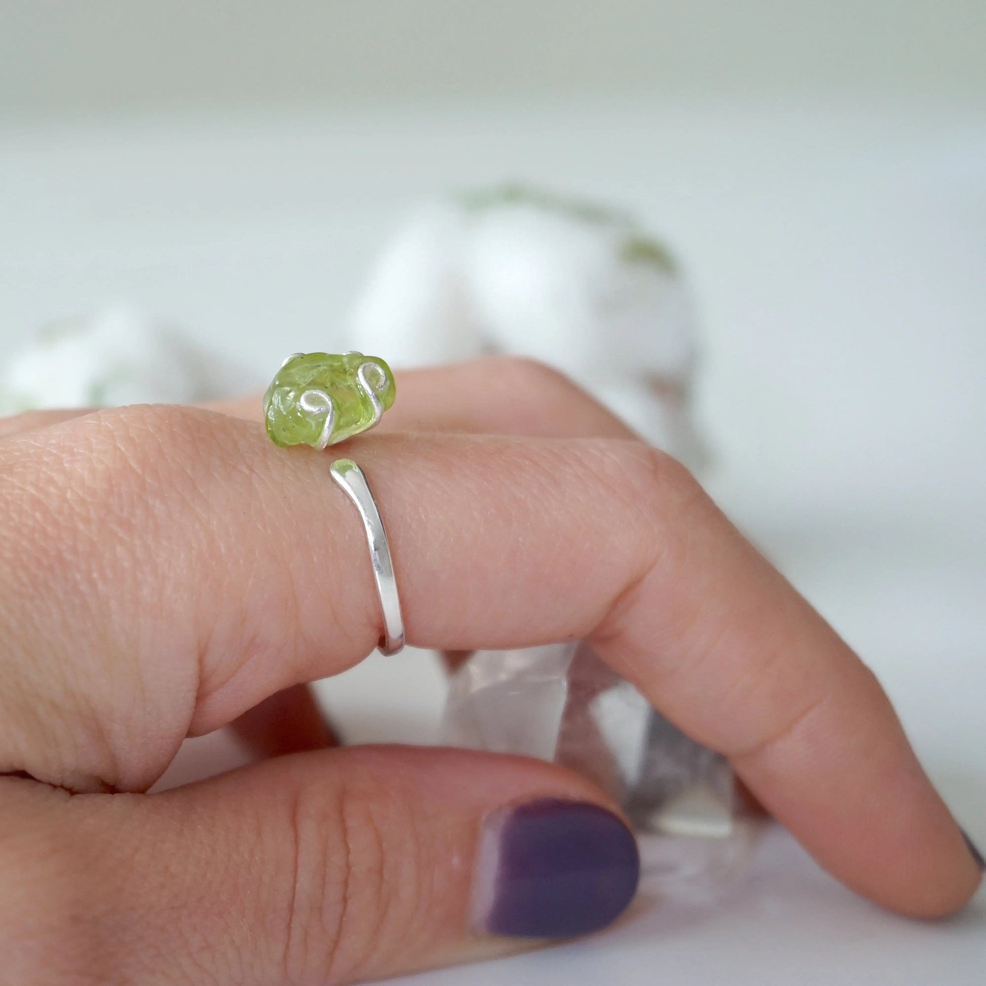 Raw peridot adjustable sterling silver ring worn on model's hand — natural olive green crystal, adjustable August birthstone crystal ring for women by Designs by Nature Gems