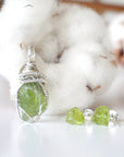 Front view of raw peridot jewelry set for women — sterling silver wire wrapped pendant and matching stud earrings, handcrafted August birthstone crystal set