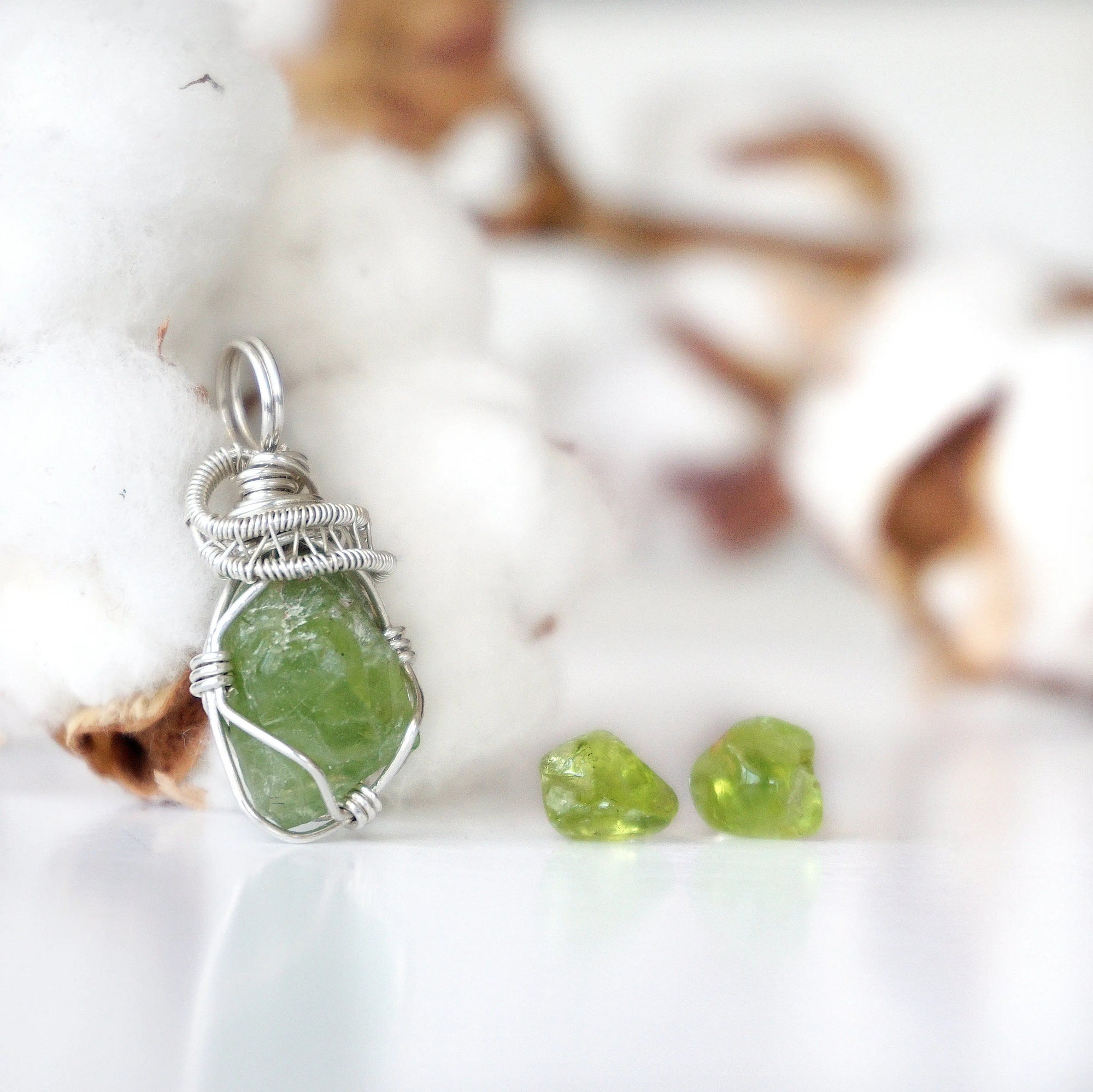 Right side detail of raw peridot pendant and stud earrings — 925 sterling silver wire wrapping artistry, handcrafted August birthstone jewelry set for women by Designs by Nature Gems