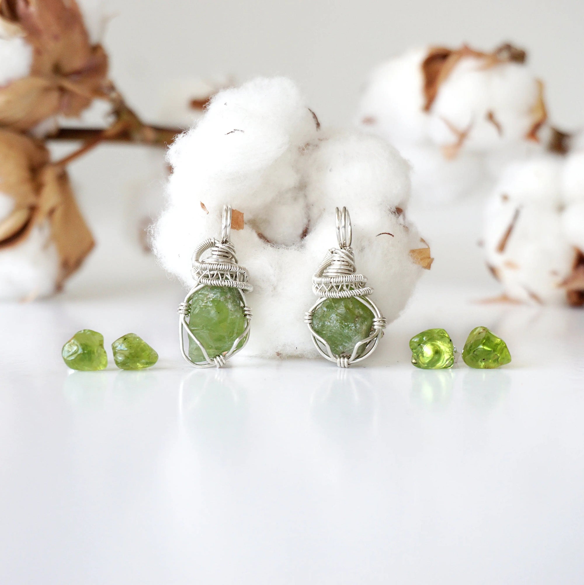 Two raw peridot jewelry sets for women showing natural variation in stone size, shape, and lime green colour — handcrafted 925 sterling silver August birthstone necklace and earring sets