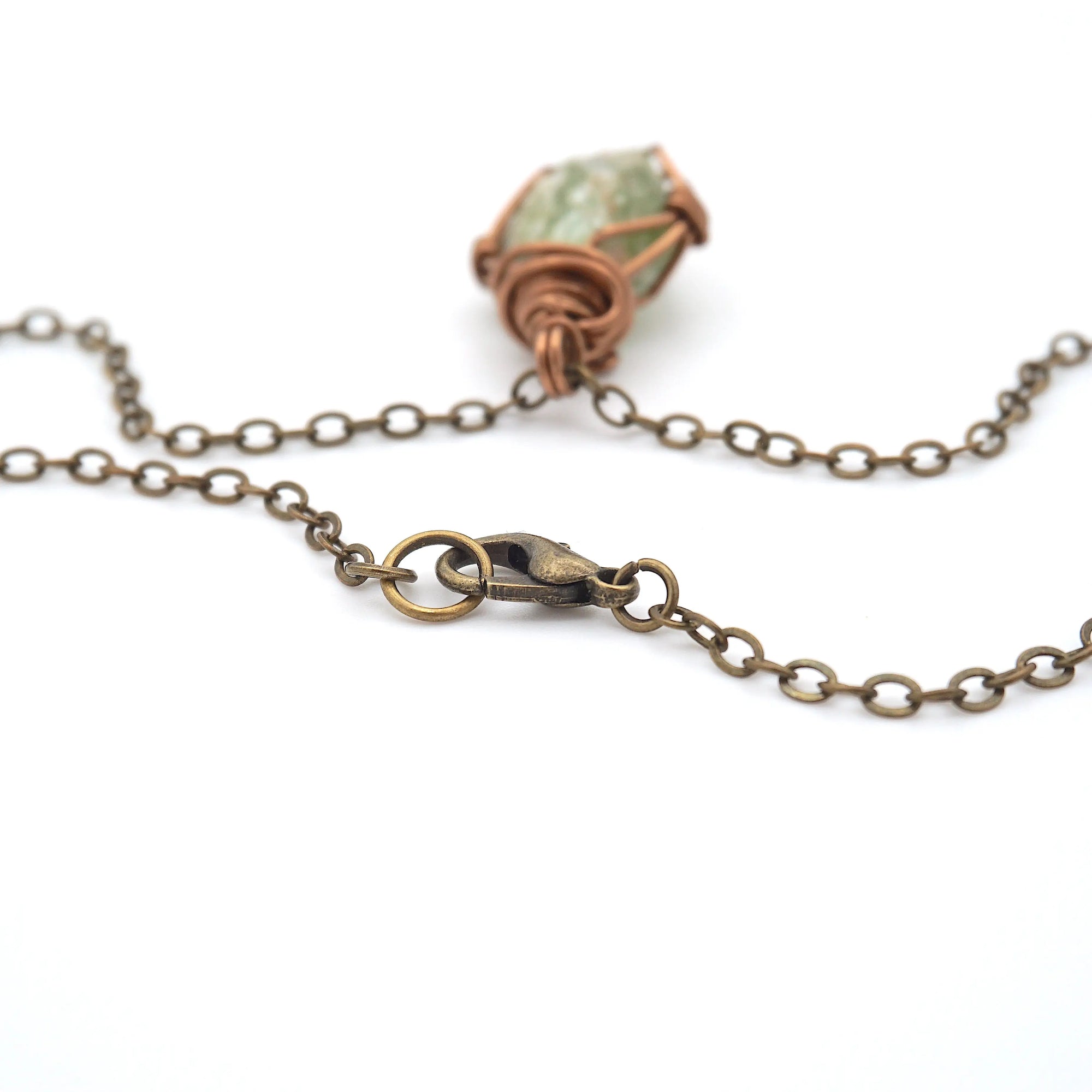 Antique bronze lobster clasp detail — raw peridot necklace closure, nickel-free handmade crystal jewelry by Designs by Nature Gems