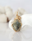 Back view of raw peridot pendant in 14k gold filled, highlighting stone and wire detail. One of a kind August birthstone jewelry by Designs by Nature Gems.