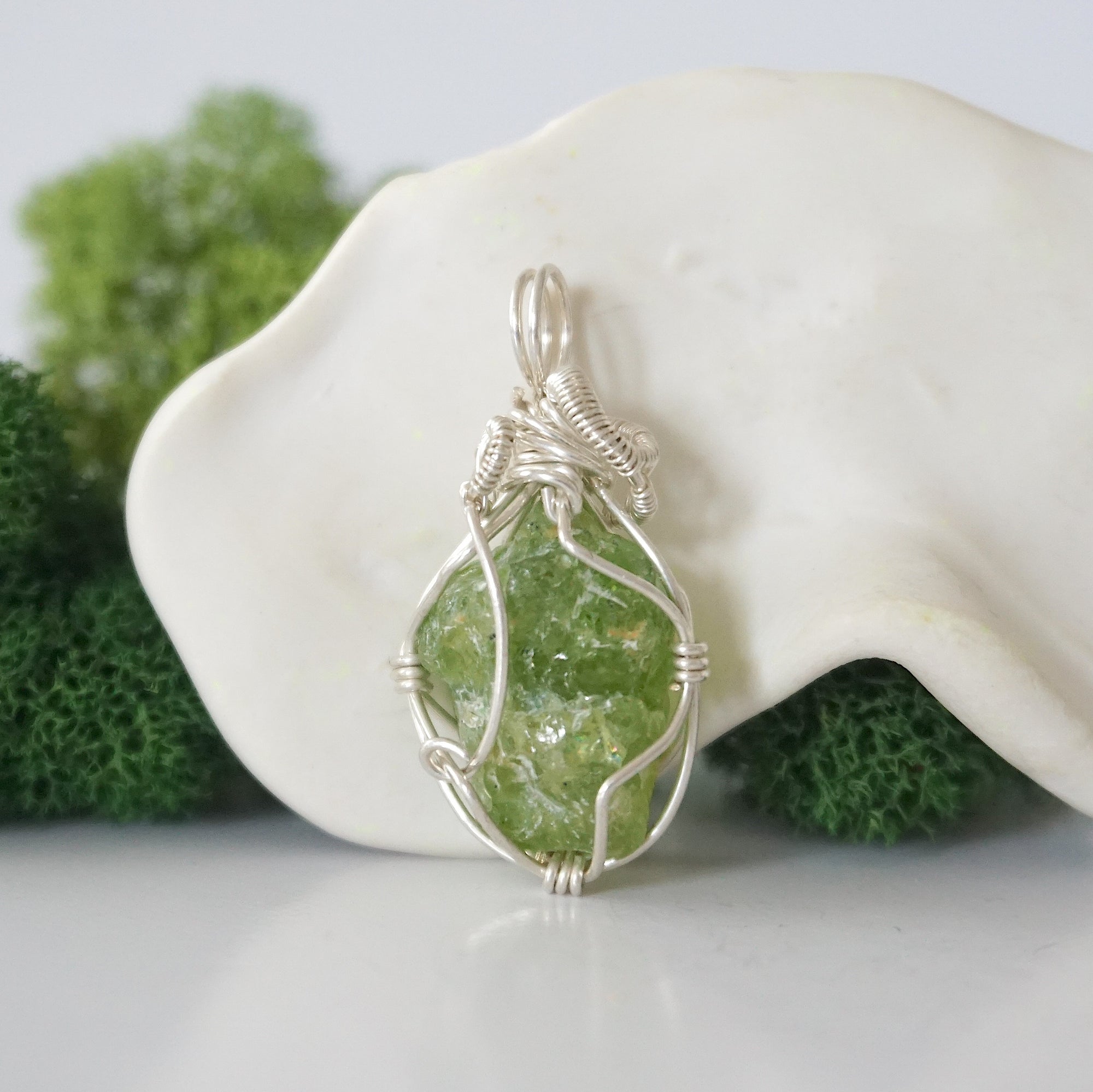 Back view of raw peridot wire wrapped pendant — 925 sterling silver hand-wrapped setting, shows craftsmanship and secure stone hold, handmade in Toronto Canada