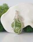 Back view of raw peridot wire wrapped pendant — 925 sterling silver hand-wrapped setting, shows craftsmanship and secure stone hold, handmade in Toronto Canada