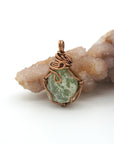 Back view of raw peridot wire wrapped pendant — antique bronze copper wire weave detail, handcrafted artisan crystal necklace