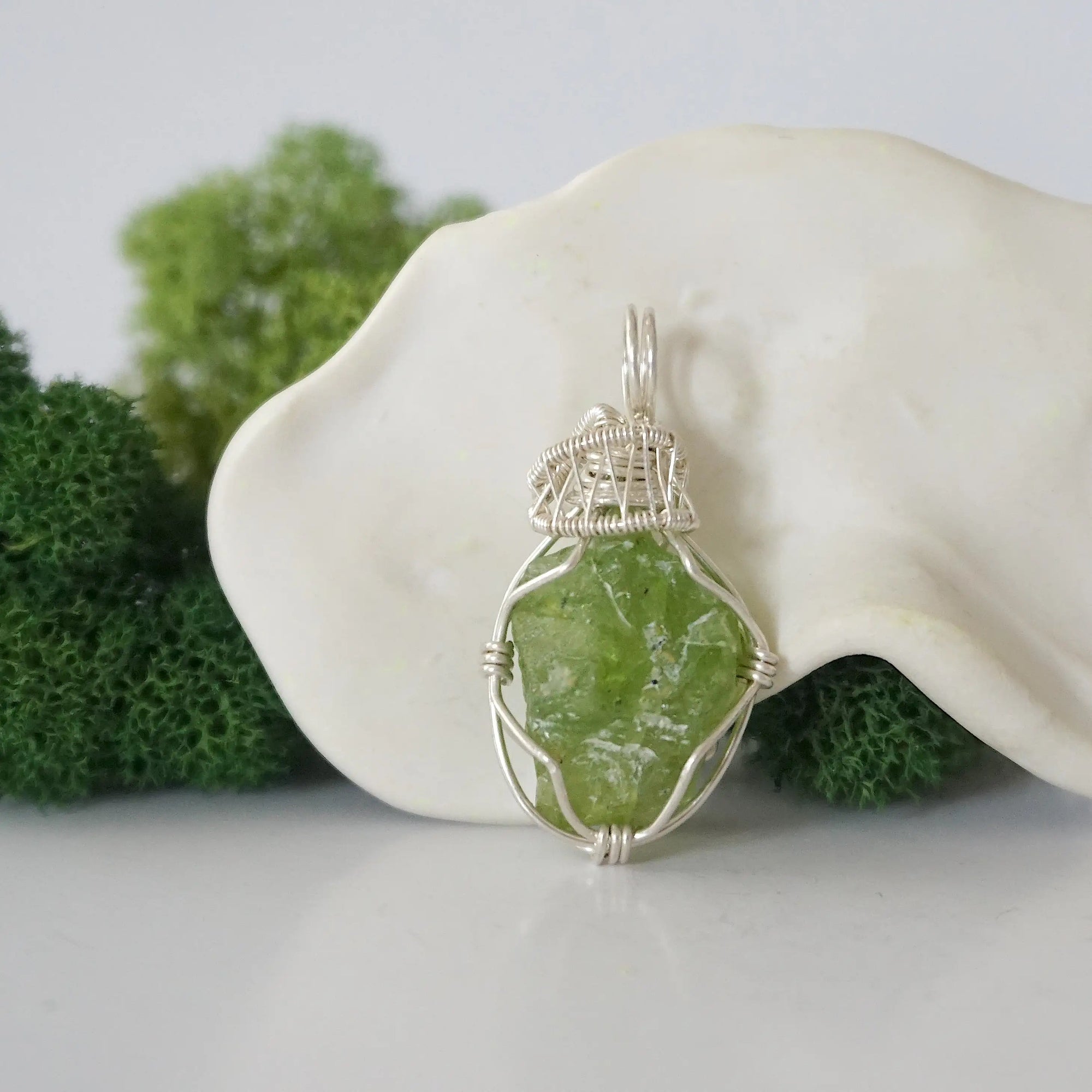 Front view of raw green peridot pendant — natural unpolished peridot stone hand-wrapped in detailed 925 sterling silver wire, handcrafted artisan jewelry