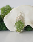 Front view of raw green peridot pendant — natural unpolished peridot stone hand-wrapped in detailed 925 sterling silver wire, handcrafted artisan jewelry