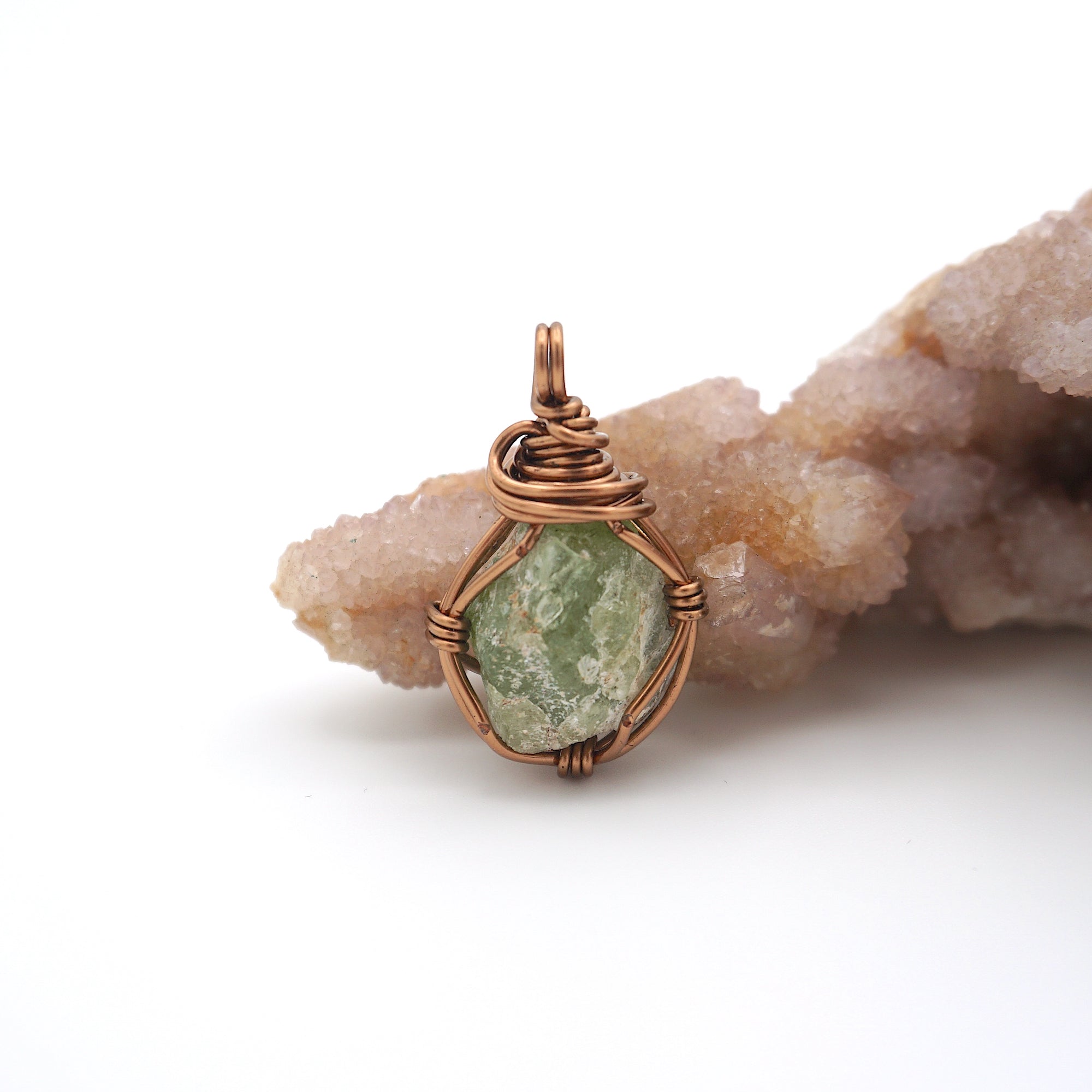 Front view of raw peridot pendant — natural olive green crystal wire wrapped in antique bronze, handcrafted August birthstone jewelry