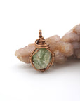 Front view of raw peridot pendant — natural olive green crystal wire wrapped in antique bronze, handcrafted August birthstone jewelry