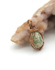 Right side detail of handmade raw peridot pendant — antique bronze wire wrapping technique, artisan crystal necklace