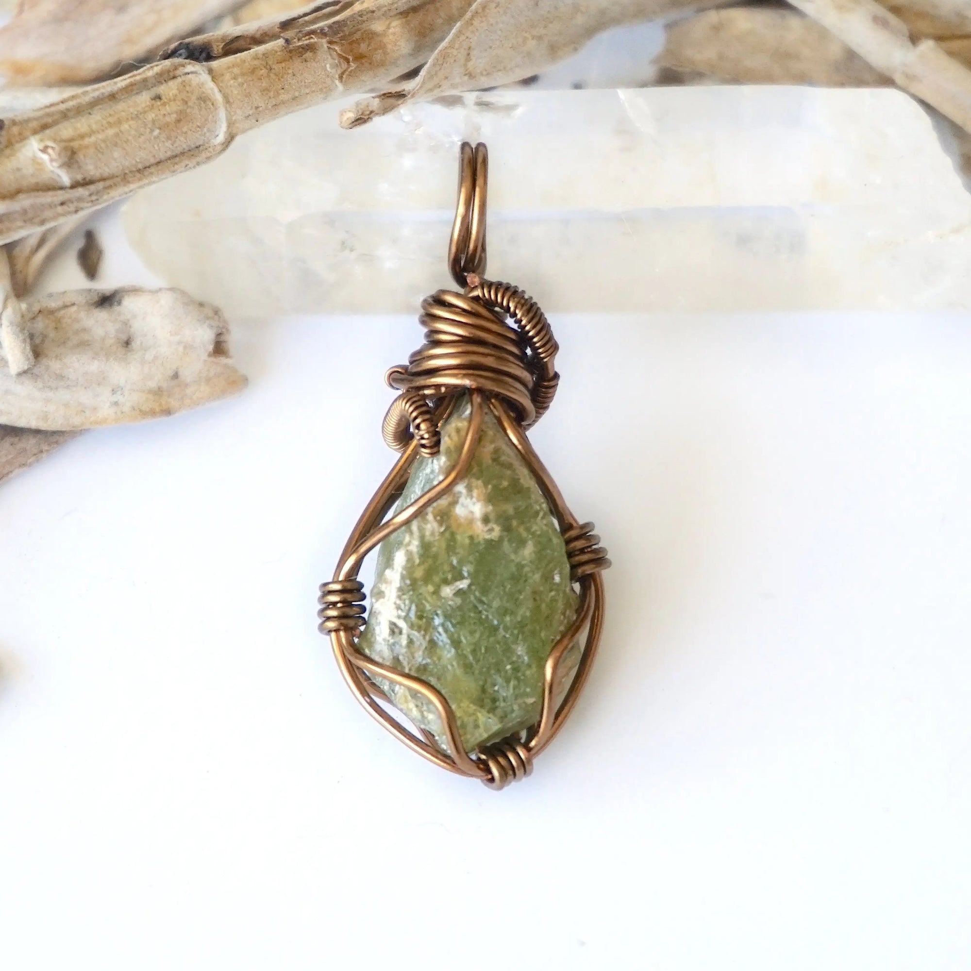 Back view of raw peridot wire wrapped pendant for women — antique bronze copper wire weave detail, handcrafted artisan crystal necklace, August birthstone jewelry