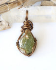 Back view of raw peridot wire wrapped pendant for women — antique bronze copper wire weave detail, handcrafted artisan crystal necklace, August birthstone jewelry