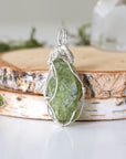 Back view of raw peridot wire wrapped pendant for women — 925 sterling silver wire weave detail, handcrafted artisan crystal necklace, August birthstone jewelry