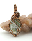 Back view of raw peridot wire wrapped pendant — antique bronze and dark silver copper wire weave detail, handcrafted artisan crystal necklace for women