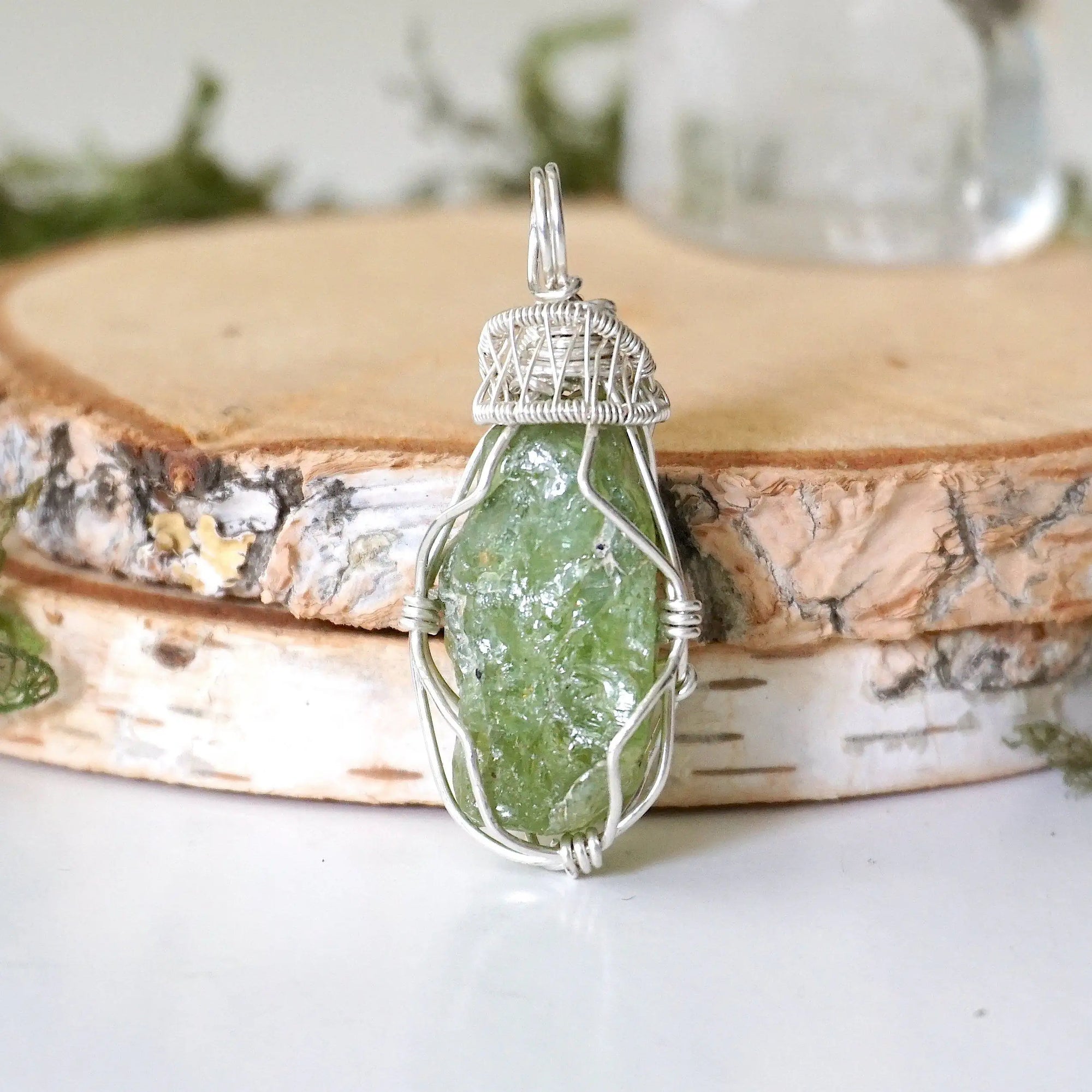 Front view of raw peridot pendant for women — vivid olive green crystal with natural surface texture, 925 sterling silver wire wrap, handcrafted August birthstone jewelry