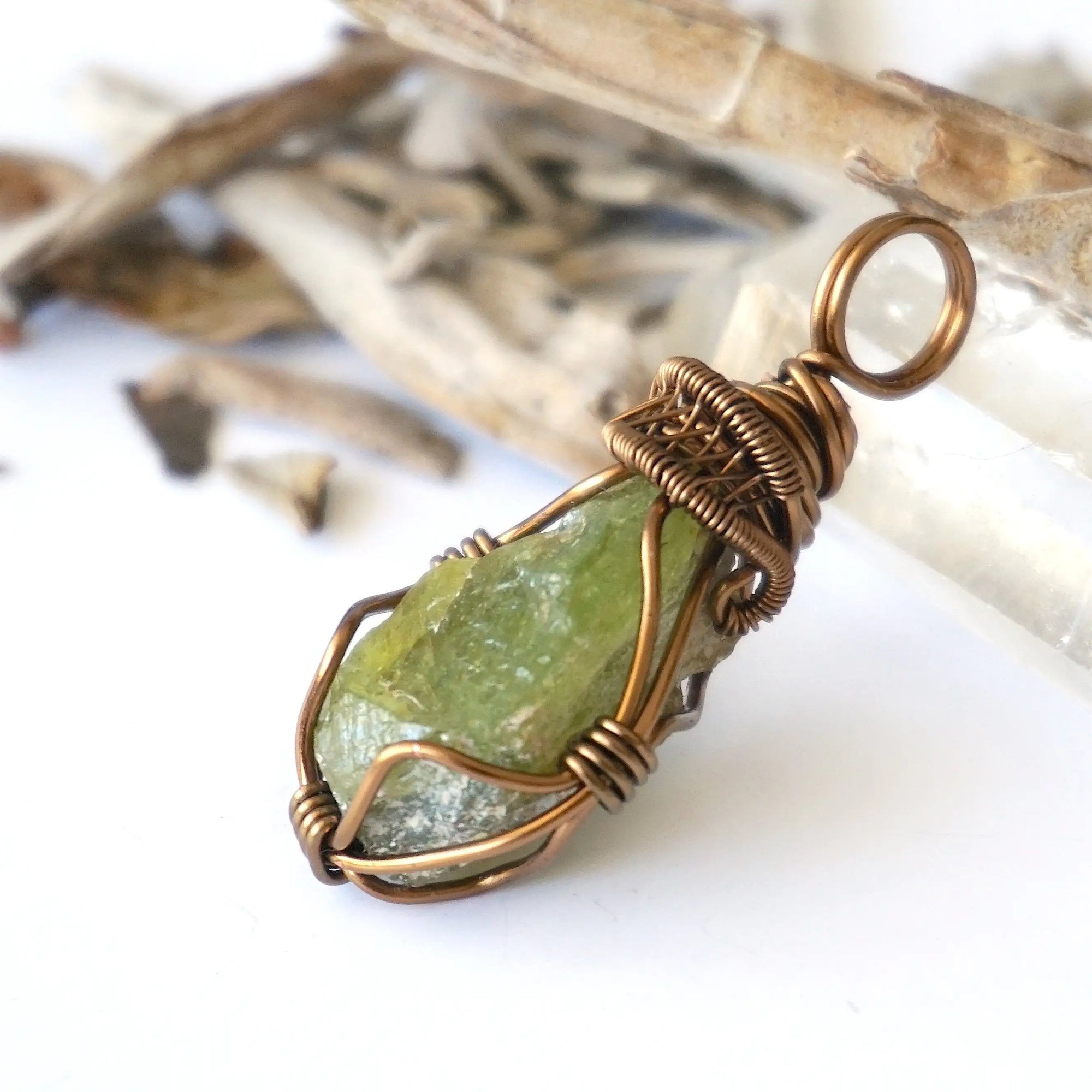 Left side detail of handmade raw peridot pendant for women — antique bronze copper wire weave and coiled bail, artisan crystal necklace by Designs by Nature Gems