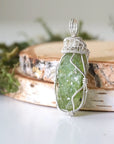 Left side detail of handmade raw peridot pendant for women — 925 sterling silver wire weave and coiled bail artistry, artisan crystal necklace by Designs by Nature Gems