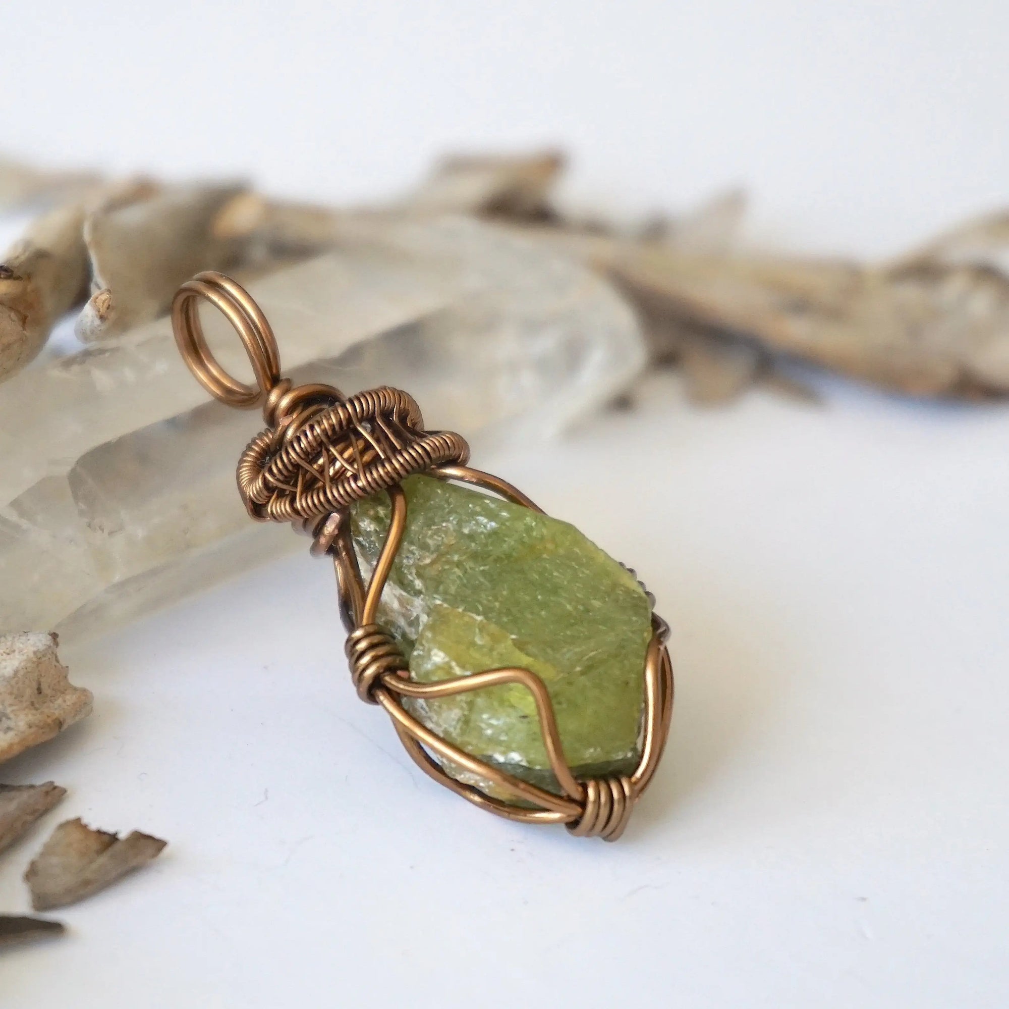 Right side detail of handmade raw peridot pendant for women — antique bronze wire wrapping technique and sculptural bail, artisan crystal jewelry by Designs by Nature Gems