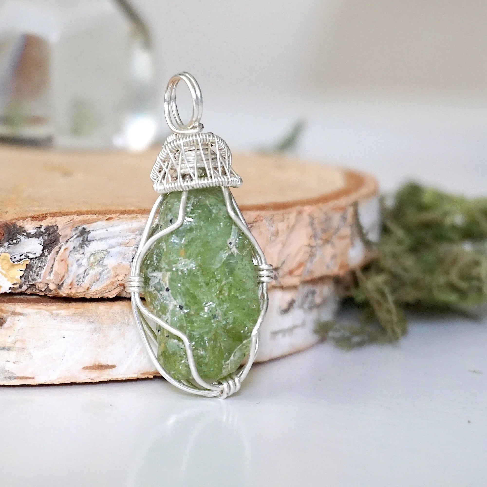 Right side detail of handmade raw peridot pendant for women — 925 sterling silver wire wrapping technique and sculptural bail, artisan crystal jewelry by Designs by Nature Gems