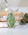 Right side detail of handmade raw peridot pendant for women — 925 sterling silver wire wrapping technique and sculptural bail, artisan crystal jewelry by Designs by Nature Gems