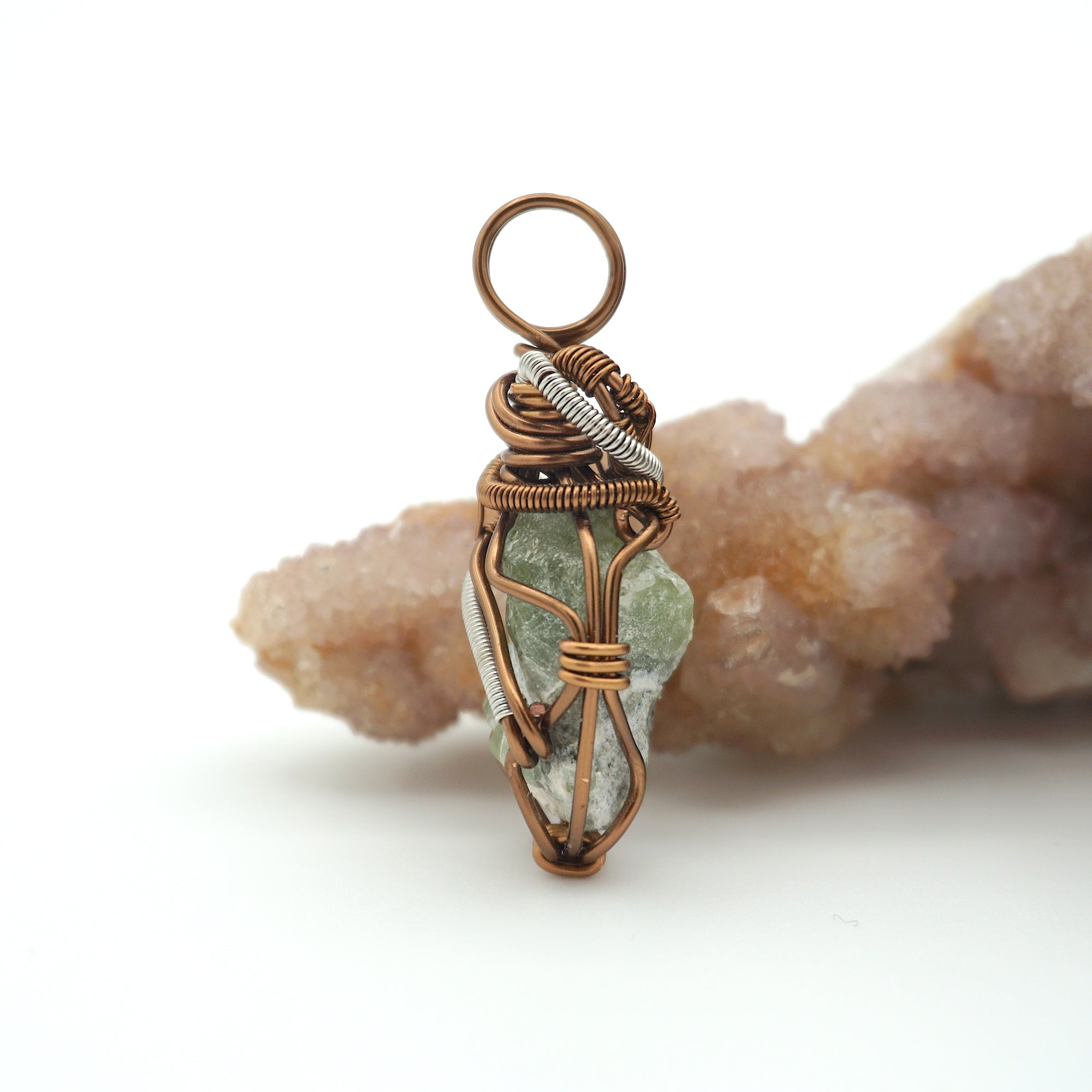 Right side detail of handmade raw peridot pendant — antique bronze and dark silver wire wrapping technique, artisan crystal jewelry for women