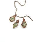 Three raw peridot pendants showing natural variation in size, shape, and olive green colour — handcrafted wire wrapped August birthstone necklaces