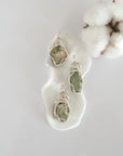 Three raw peridot pendants showing natural variation in stone size, shape, and green colour — each one of a kind, August birthstone, silver wire wrapped, Designs by Nature Gems