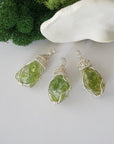 Three raw peridot pendants showing natural variation in stone size, shape, and green colour — each one of a kind, August birthstone, 925 sterling silver wire wrapped, Designs by Nature Gems