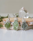 Three raw peridot pendants for women showing natural variation in size, shape, and olive green colour — handcrafted 925 sterling silver wire wrapped August birthstone necklaces