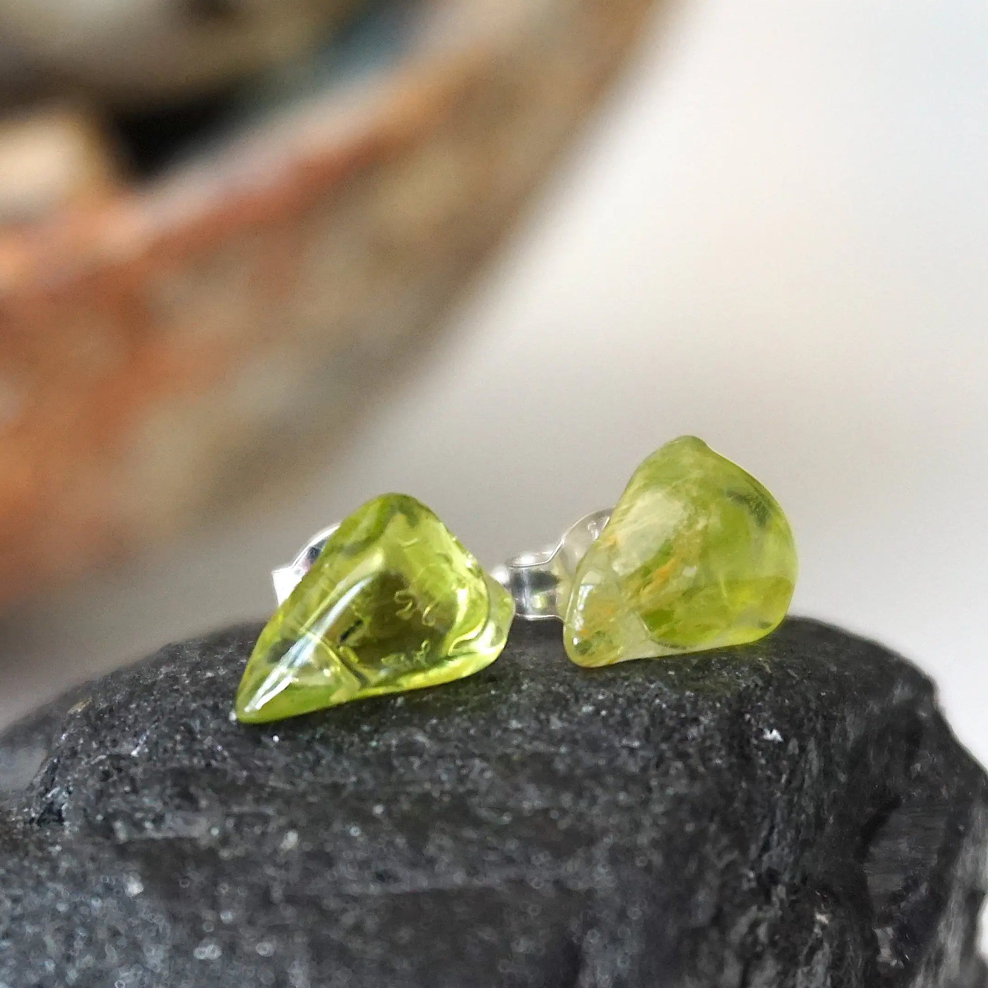 Right angle view of raw peridot stud earrings — natural olive green crystal profile on 925 sterling silver posts, handcrafted August birthstone crystal studs for women