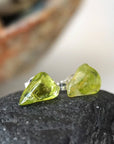 Right angle view of raw peridot stud earrings — natural olive green crystal profile on 925 sterling silver posts, handcrafted August birthstone crystal studs for women