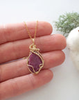 Raw pink ruby necklace in 14k gold filled shown in hand for size reference. Artisan July birthstone pendant by Designs by Nature Gems.