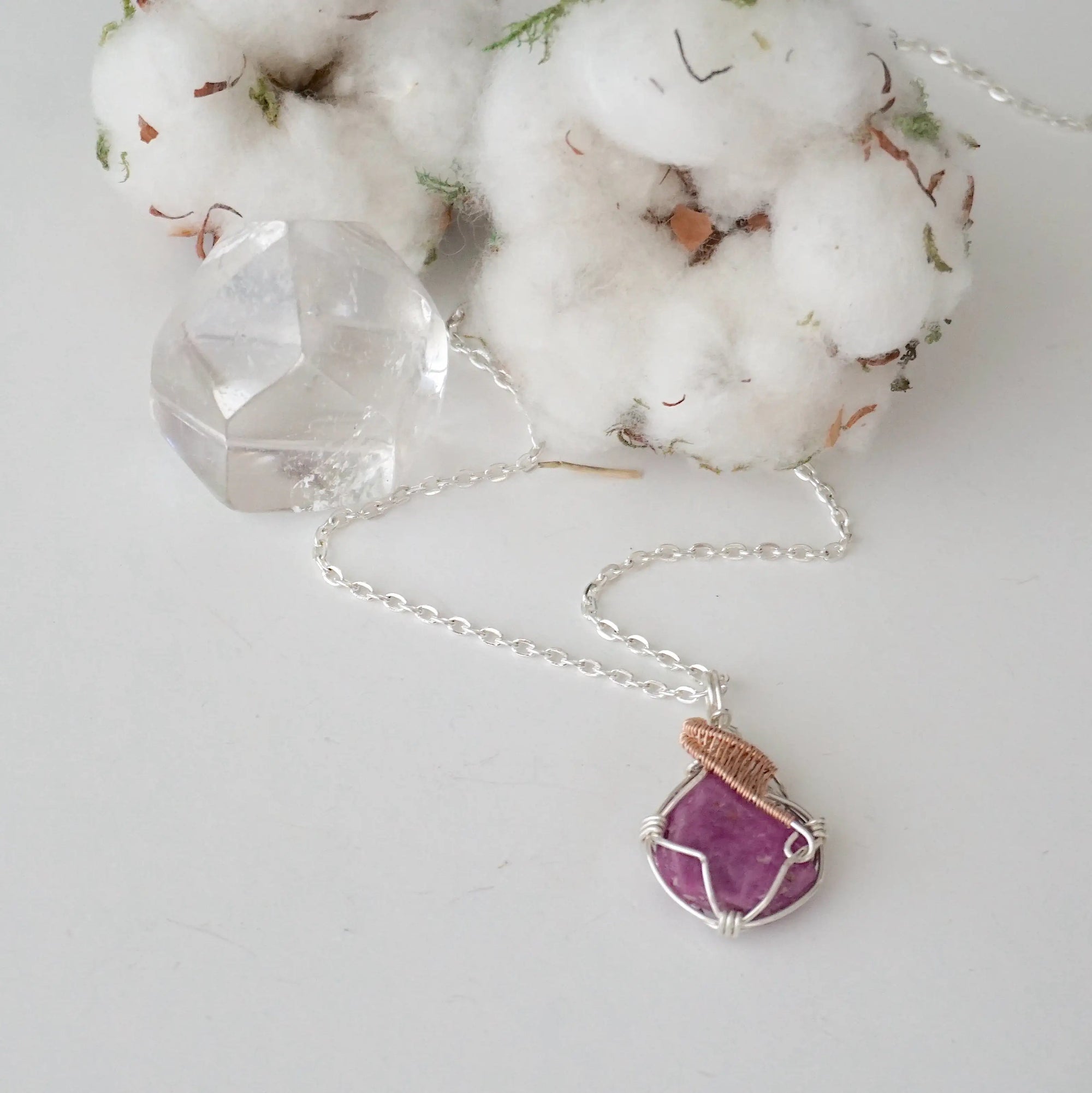 Raw pink ruby necklace in sterling silver and 14k rose gold filled laying flat. Handcrafted July birthstone jewelry for women by Designs by Nature Gems.