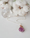 Raw pink ruby necklace in sterling silver and 14k rose gold filled laying flat. Handcrafted July birthstone jewelry for women by Designs by Nature Gems.