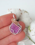 Raw pink ruby necklace in sterling silver and 14k rose gold filled shown in hand for size reference. Artisan July birthstone pendant by Designs by Nature Gems.