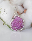 Back view of raw pink ruby pendant in sterling silver and 14k rose gold filled, highlighting stone and wire detail. One of a kind July birthstone jewelry by Designs by Nature Gems.