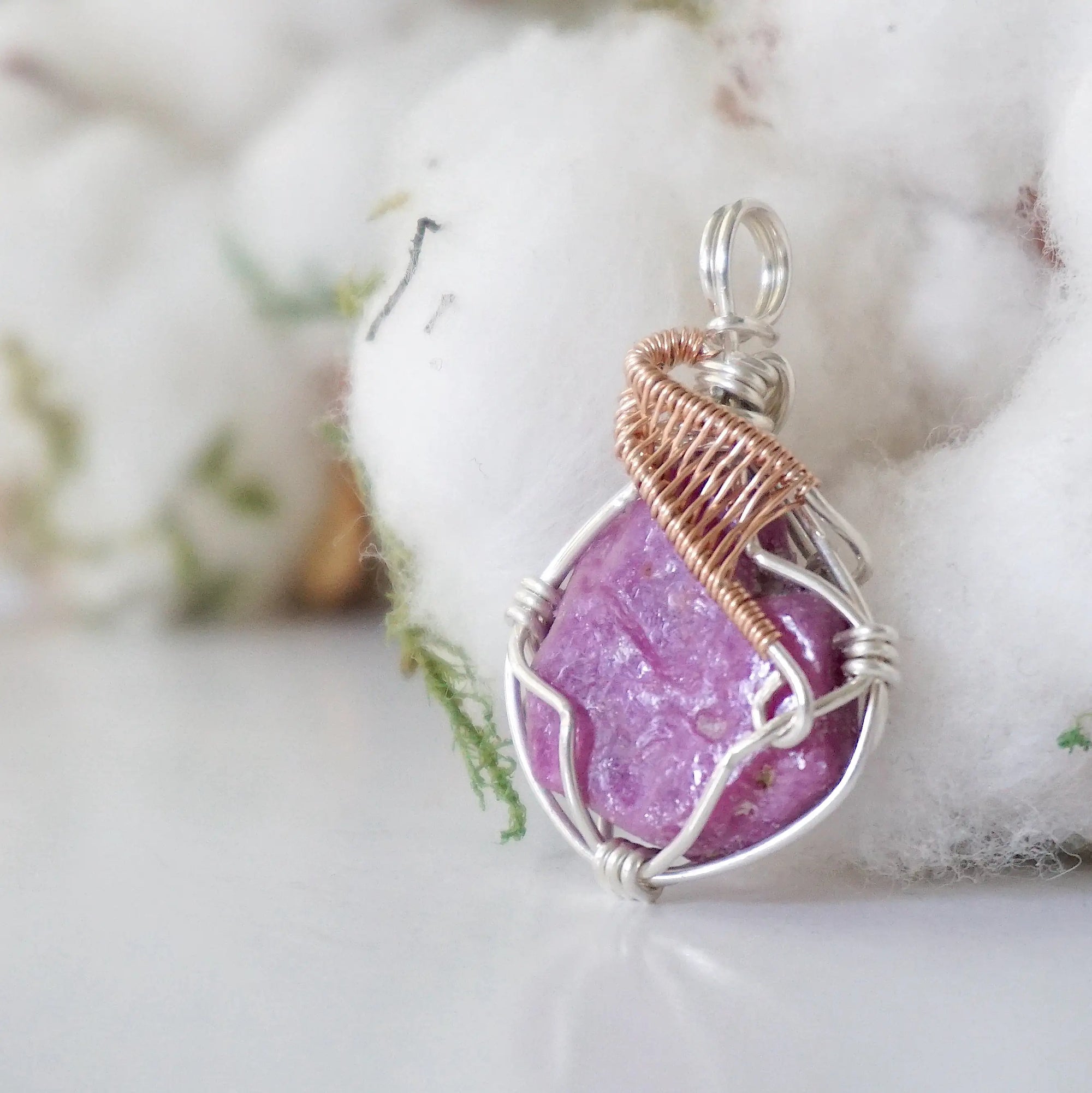 Side view of raw pink ruby pendant in sterling silver and 14k rose gold filled, showing artisan wire wrapping. Handcrafted July birthstone necklace by Designs by Nature Gems.