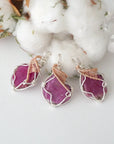 Three raw pink ruby pendants in sterling silver and 14k rose gold filled, showing natural variation in size, shape, and color. Handcrafted July birthstone jewelry by Designs by Nature Gems.