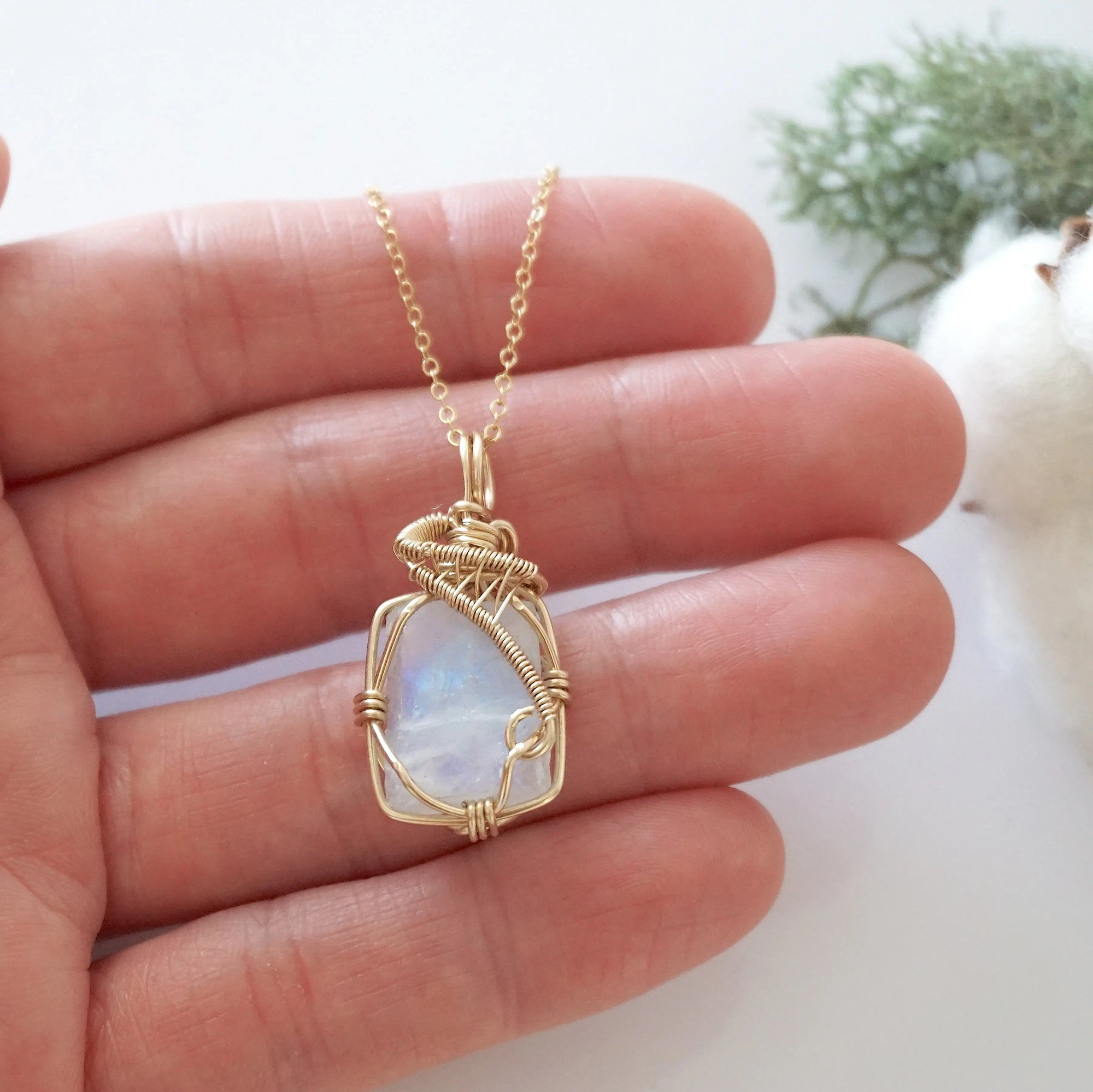 Raw rainbow moonstone necklace in 14k gold filled shown in hand for size reference. Artisan June birthstone pendant by Designs by Nature Gems.