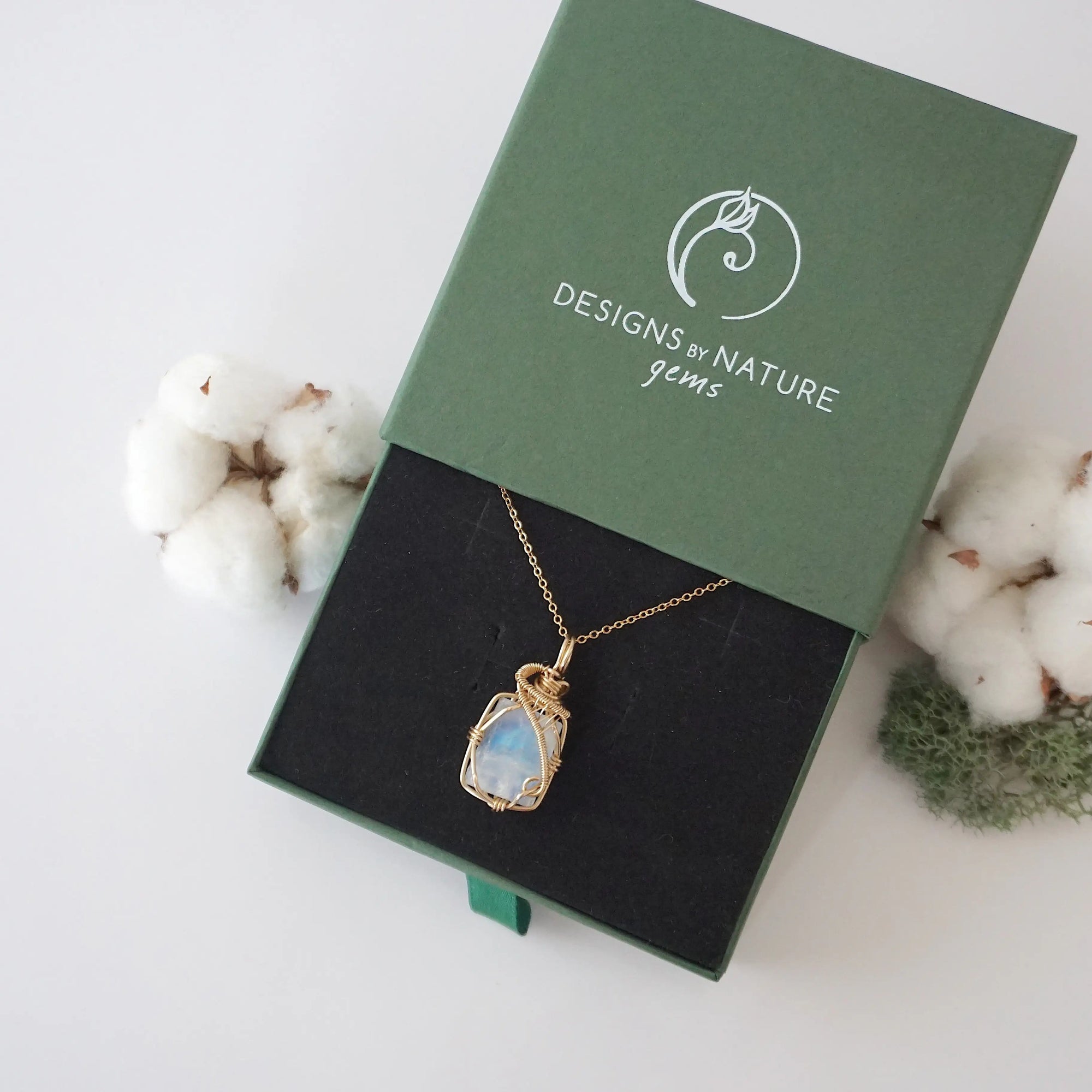 Raw rainbow moonstone necklace in 14k gold filled displayed in branded Designs by Nature Gems jewelry box. Artisan June birthstone gift for women.
