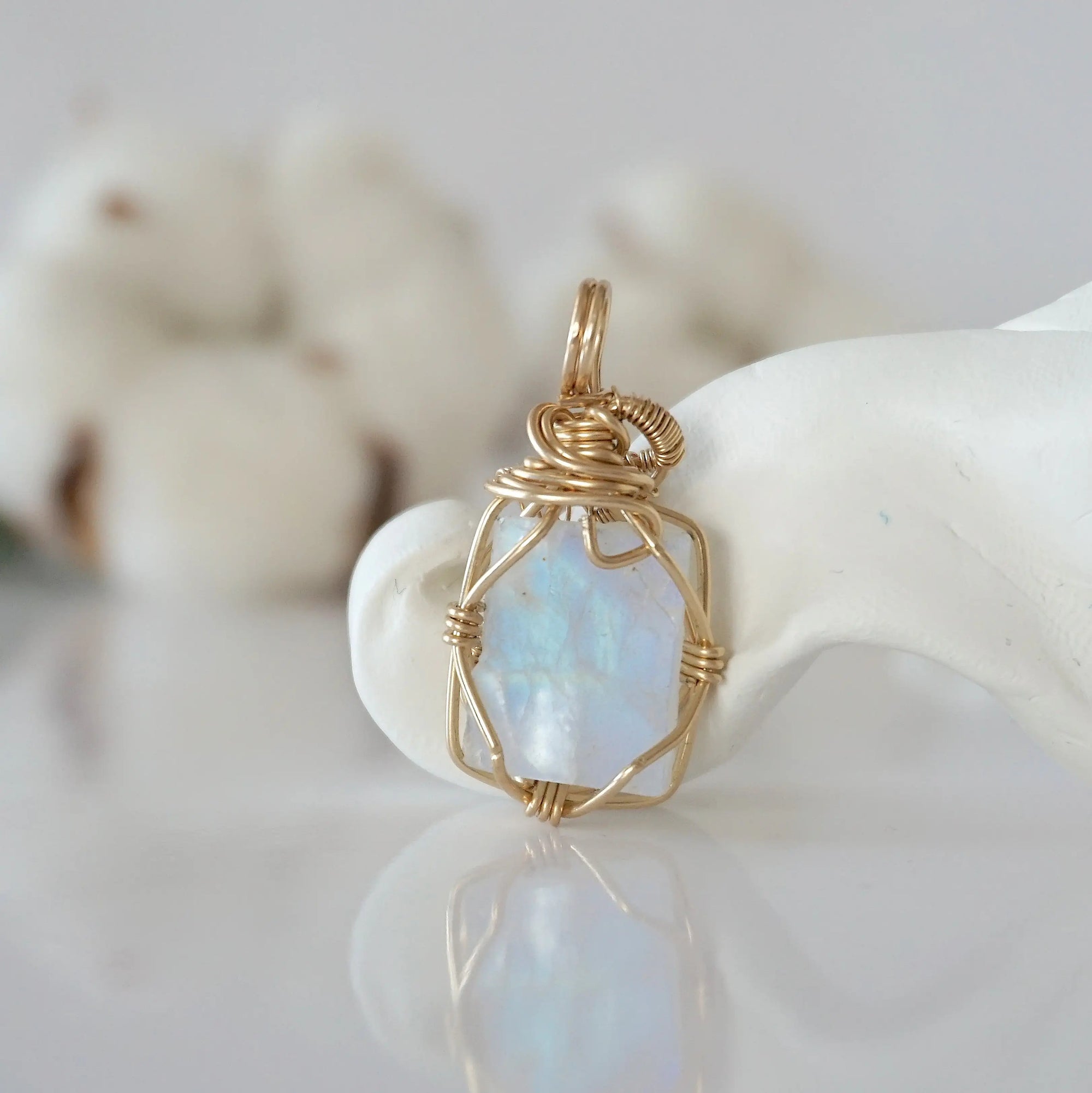 Back view of raw rainbow moonstone pendant in 14k gold filled, highlighting stone and wire detail. One of a kind June birthstone jewelry by Designs by Nature Gems.